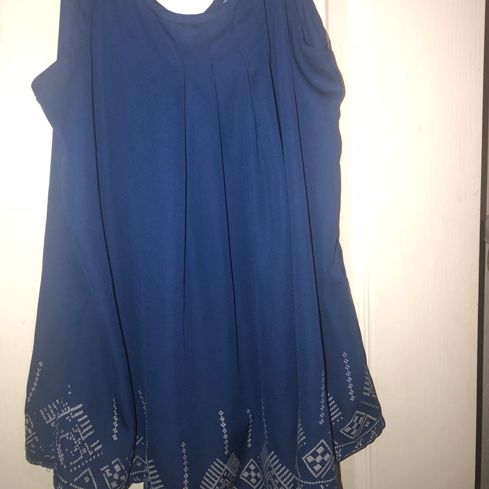 blue tank top with white design at bottom